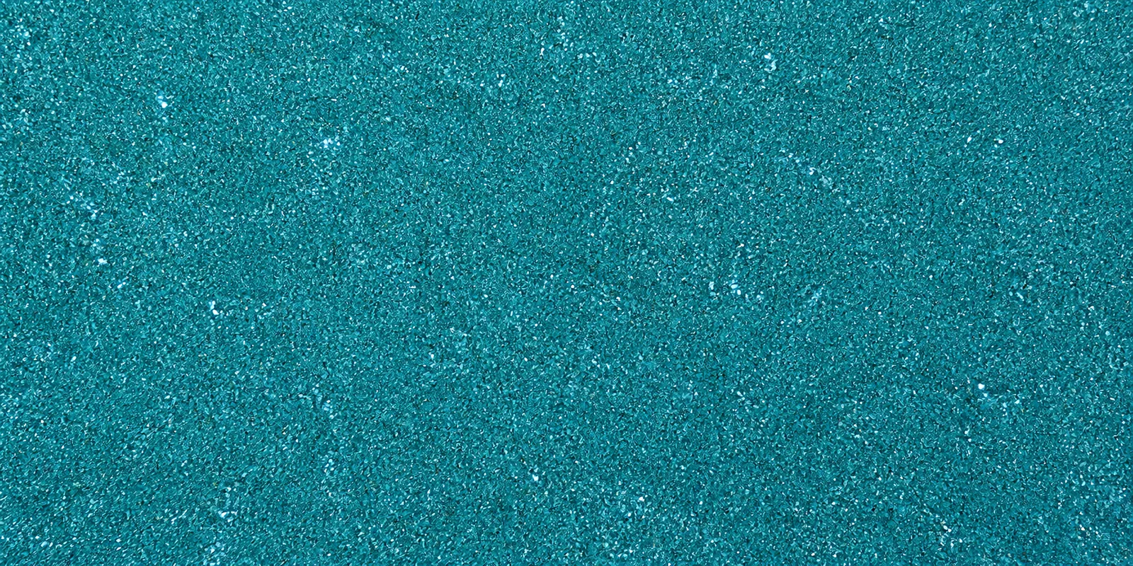 Macro del papel con glitter celeste luna de unicornio, con las partículas separadas brillando sobre la hoja