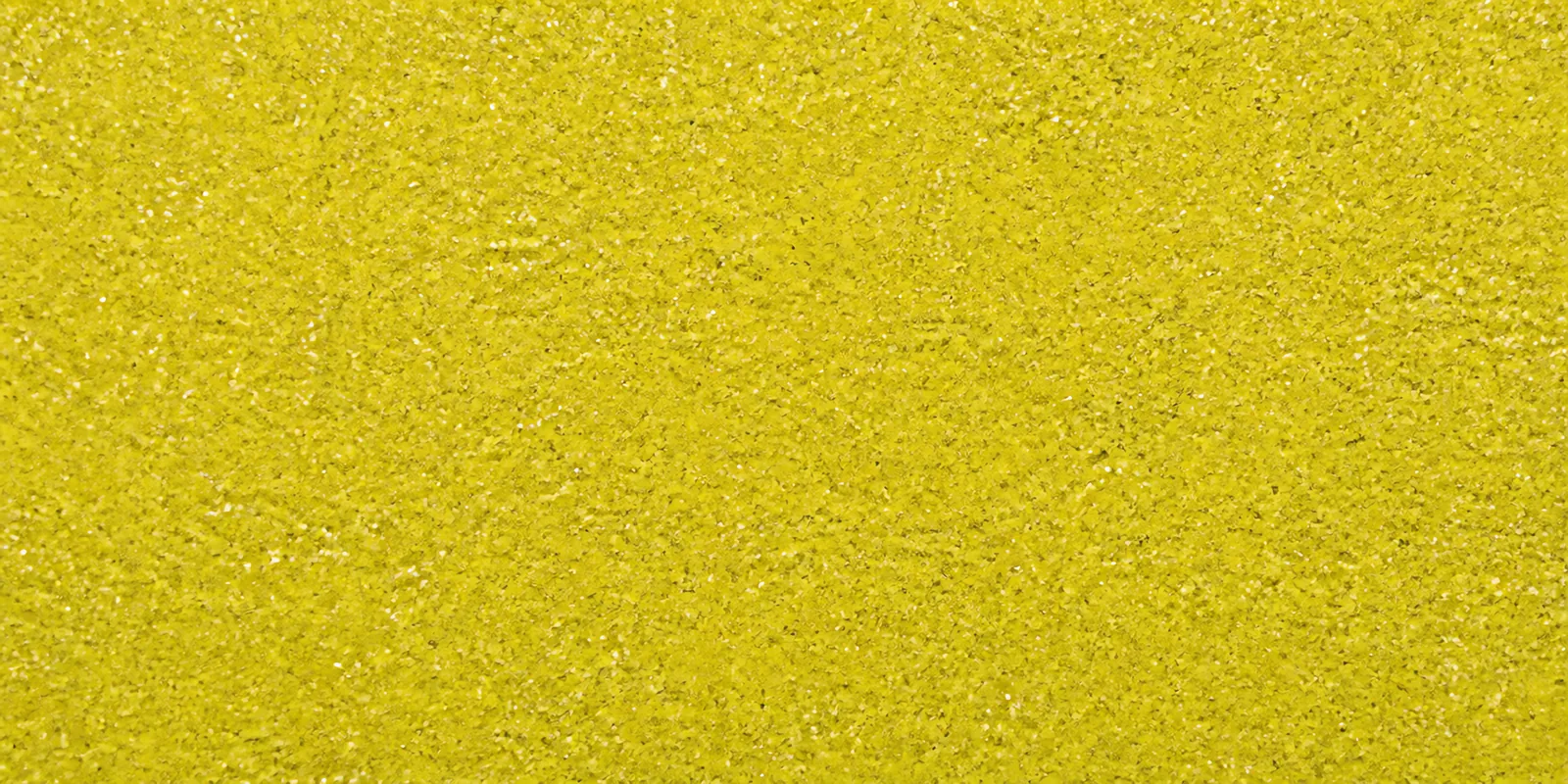 Macro del papel con glitter dorado estrella, con las partículas separadas brillando sobre la hoja