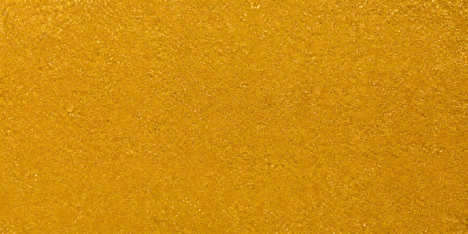 Macro del papel con glitter oro anillo encantad, con las partículas separadas brillando sobre la hoja