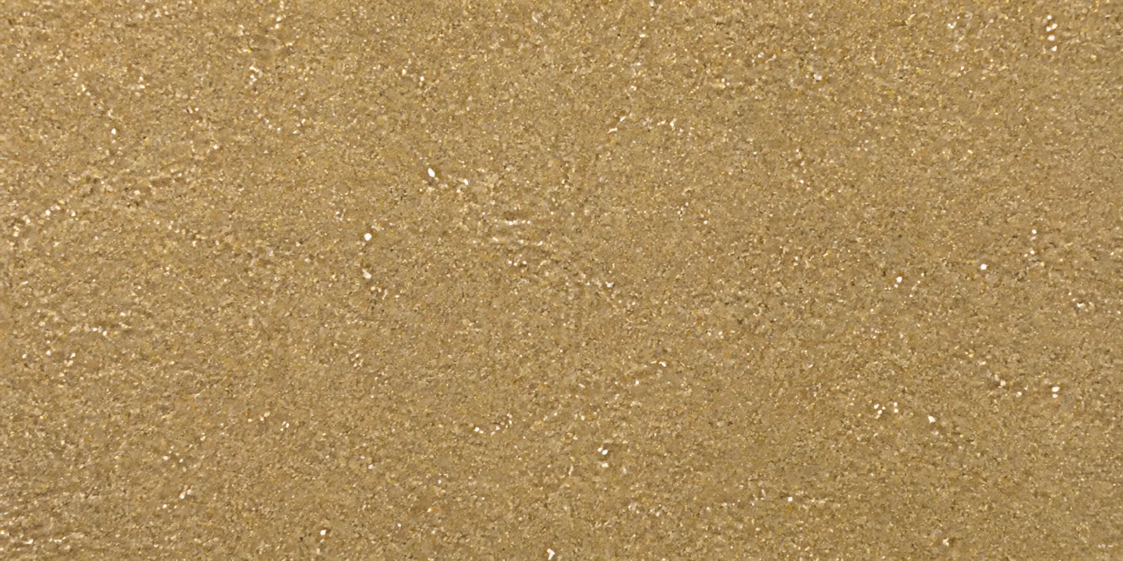 Macro del papel con glitter oro polvo magico, con las partículas separadas brillando sobre la hoja