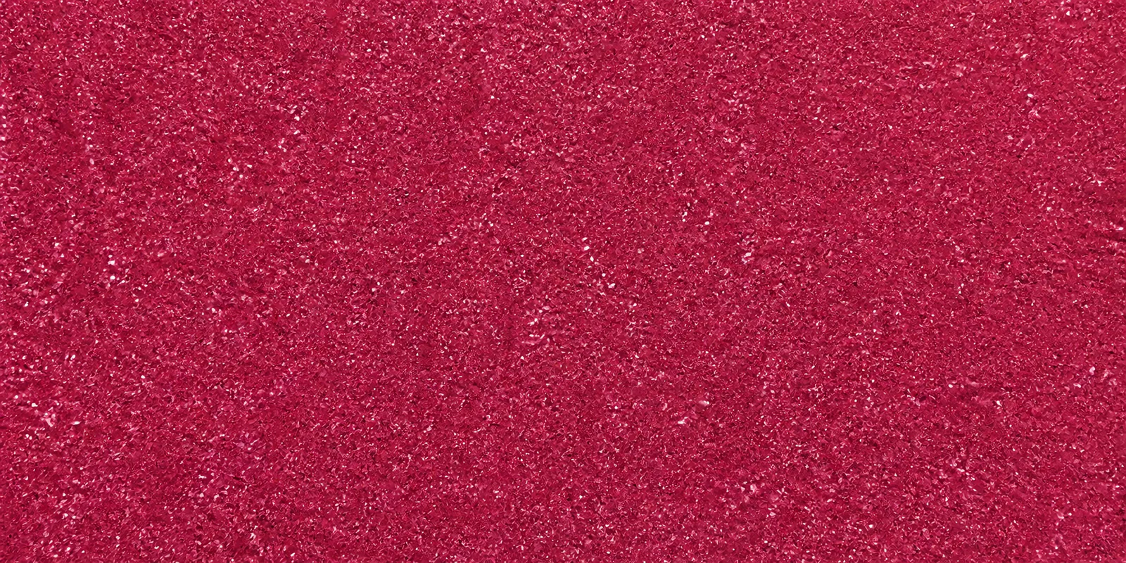 Macro del papel con glitter rosa sirena, con las partículas separadas brillando sobre la hoja