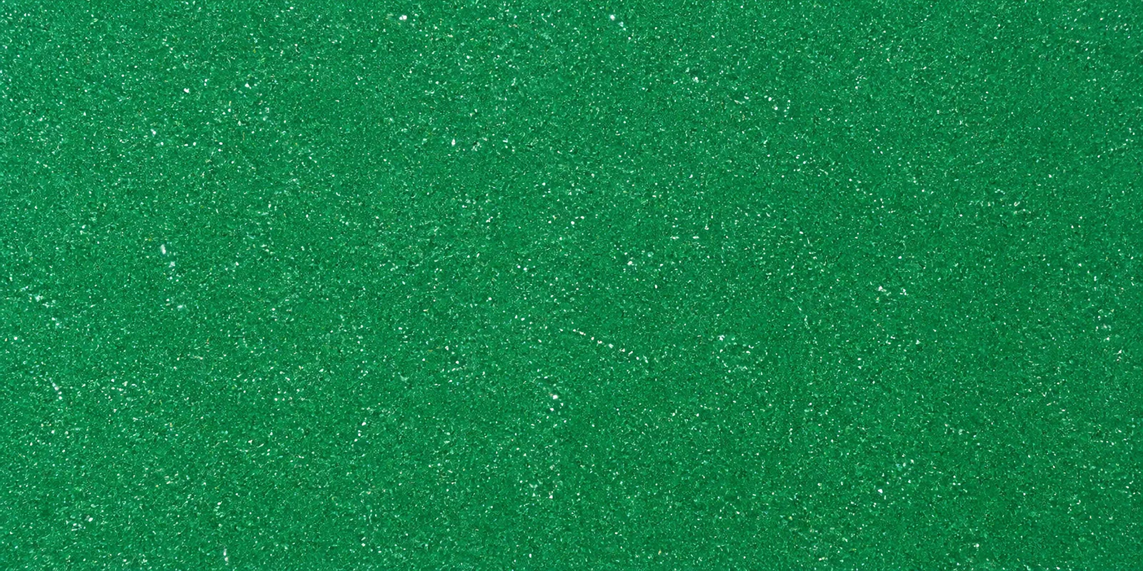 Macro de una hoja verde jade de Gliterina, con el glitter bajo el film plástico