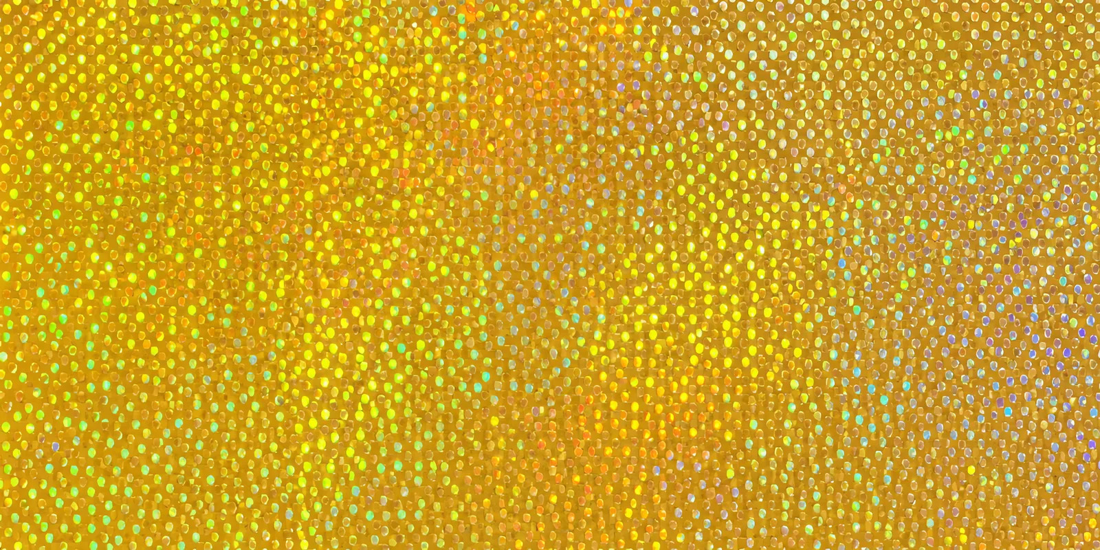 Superficie del papel metalizado Metalina, con el reflejo corriendo sobre la hoja, en el acabado confeti dorado