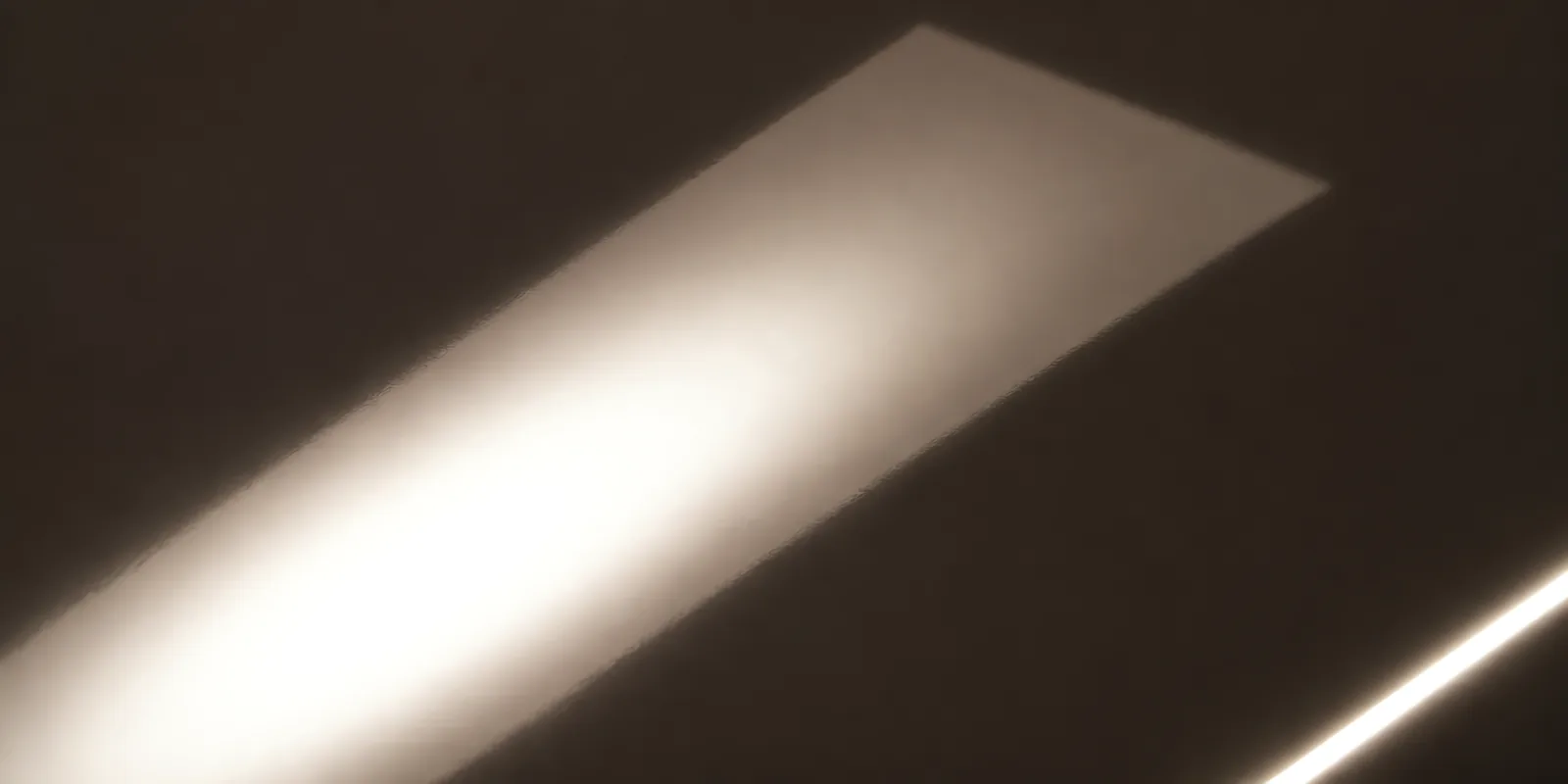 Superficie del papel metalizado Metalina, con el reflejo corriendo sobre la hoja, en el acabado negro