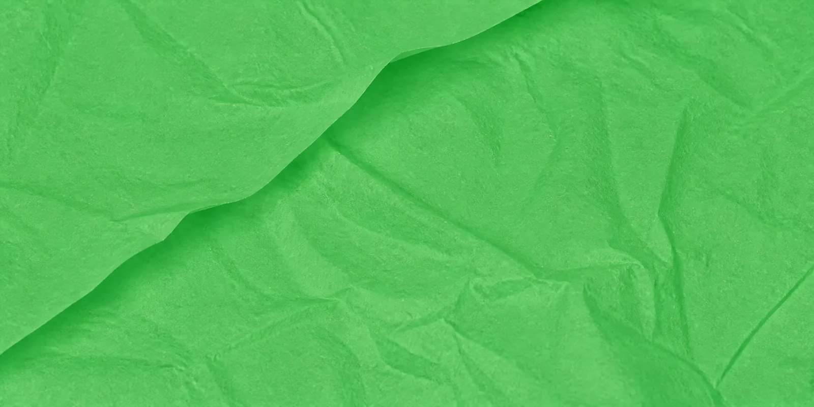 Textura del papel seda verde manzana, con sus arrugas finas y sus pliegues