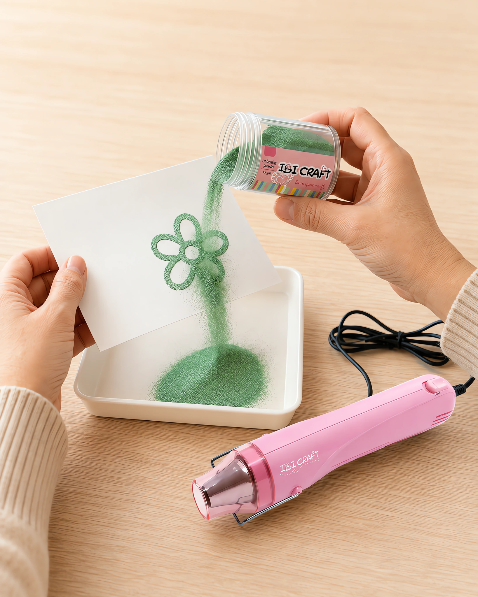 Manos espolvoreando el polvo de embossing sobre el sello húmedo