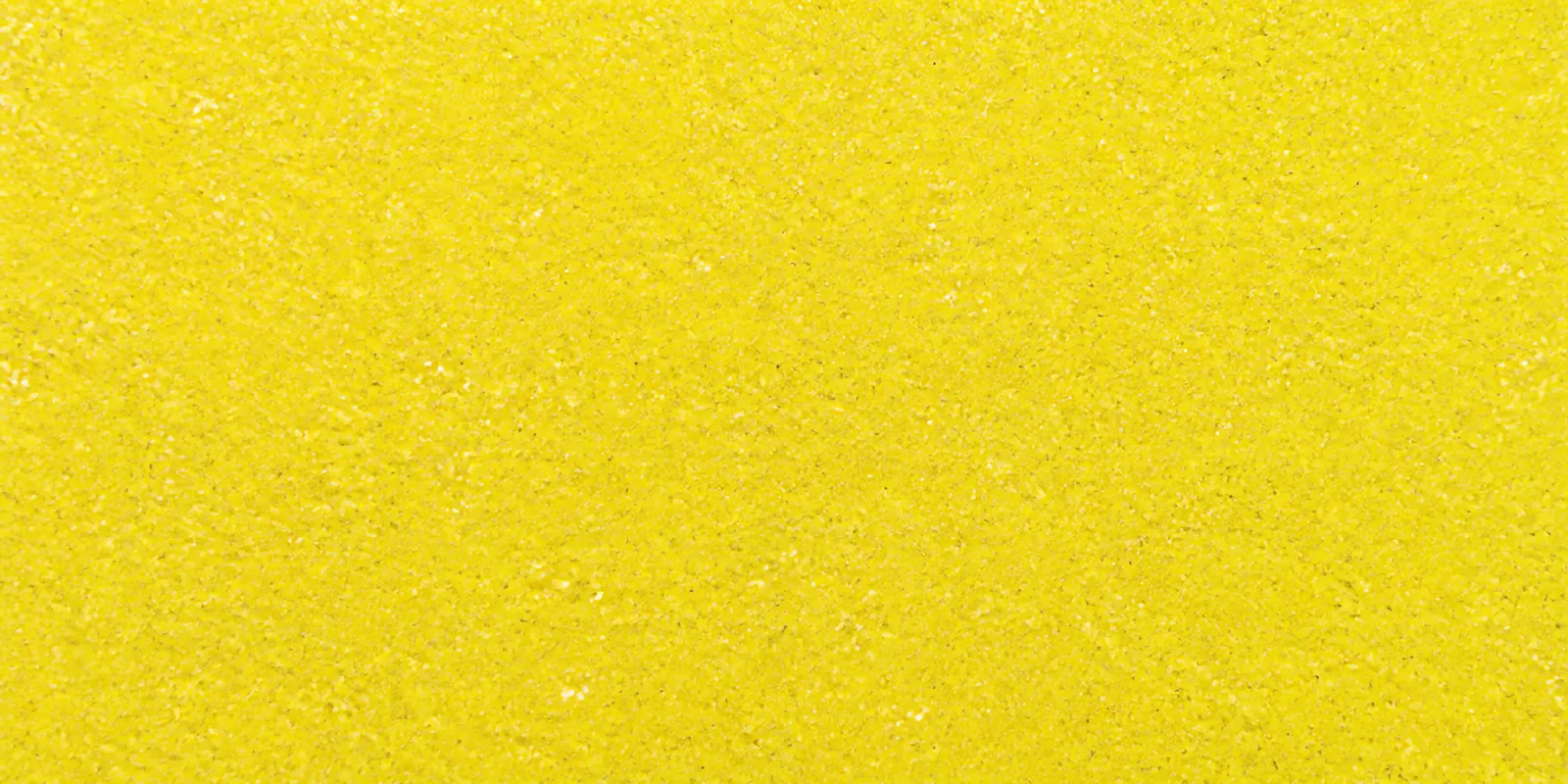 Macro del papel con glitter amarillo carruaje brillante, con las partículas separadas brillando sobre la hoja