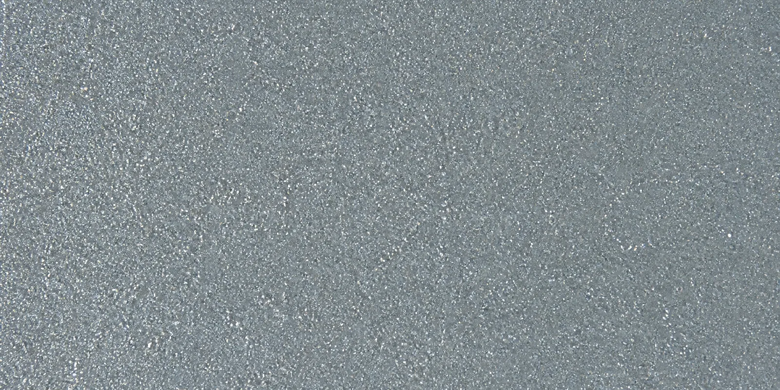 Macro del papel con glitter azul mar misterioso, con las partículas separadas brillando sobre la hoja