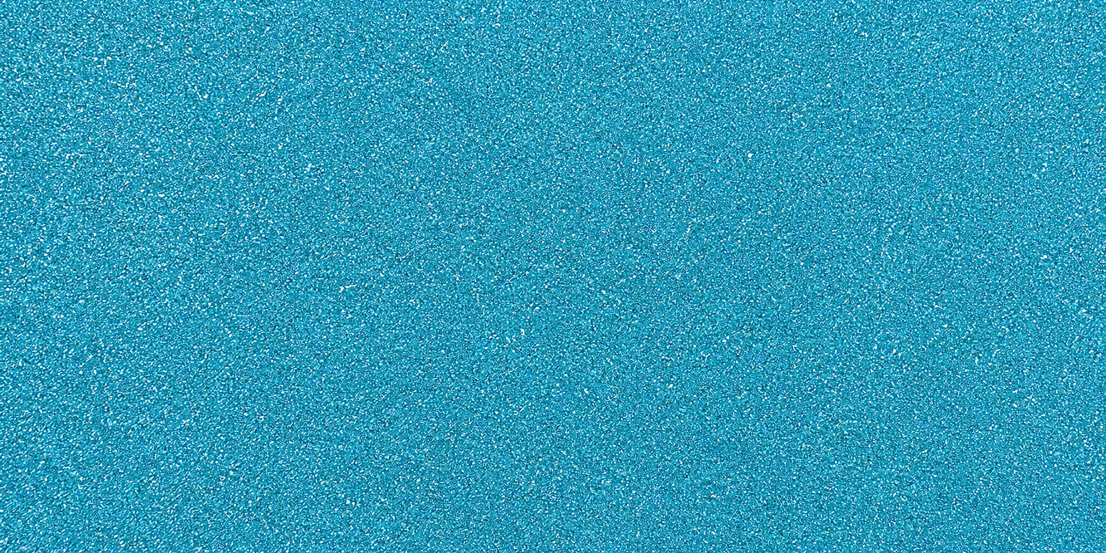 Macro del papel con glitter azul principe encantador, con las partículas separadas brillando sobre la hoja