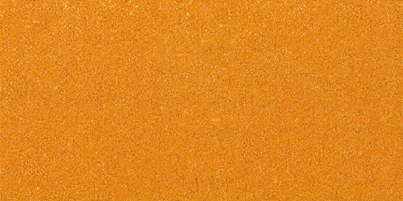 Macro del papel con glitter naranja llama encantada, con las partículas separadas brillando sobre la hoja