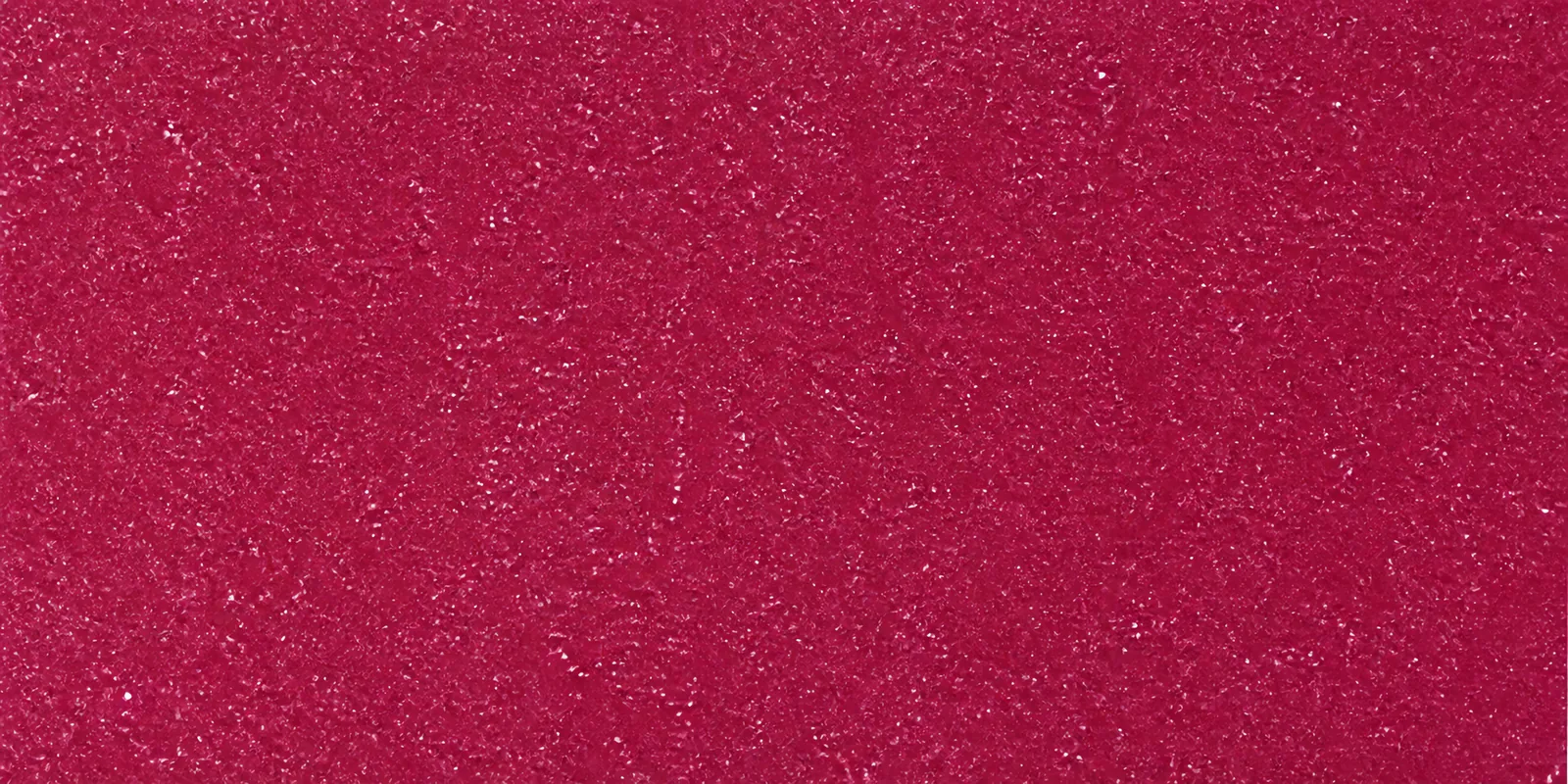 Macro de una hoja fucsia de Gliterina, con el glitter bajo el film plástico