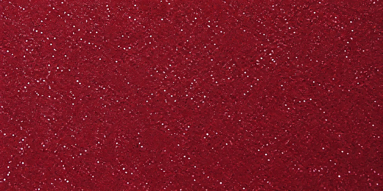 Macro de una hoja rojo granate de Gliterina, con el glitter bajo el film plástico