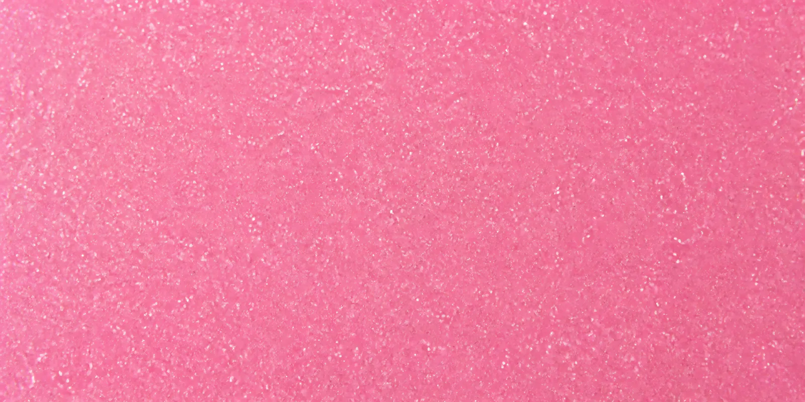 Macro de una hoja rosa viejo de Gliterina, con el glitter bajo el film plástico