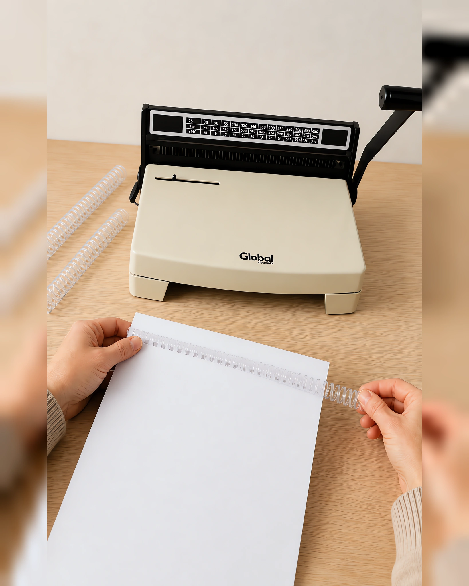 Manos enroscando el espiral plástico en un cuaderno perforado