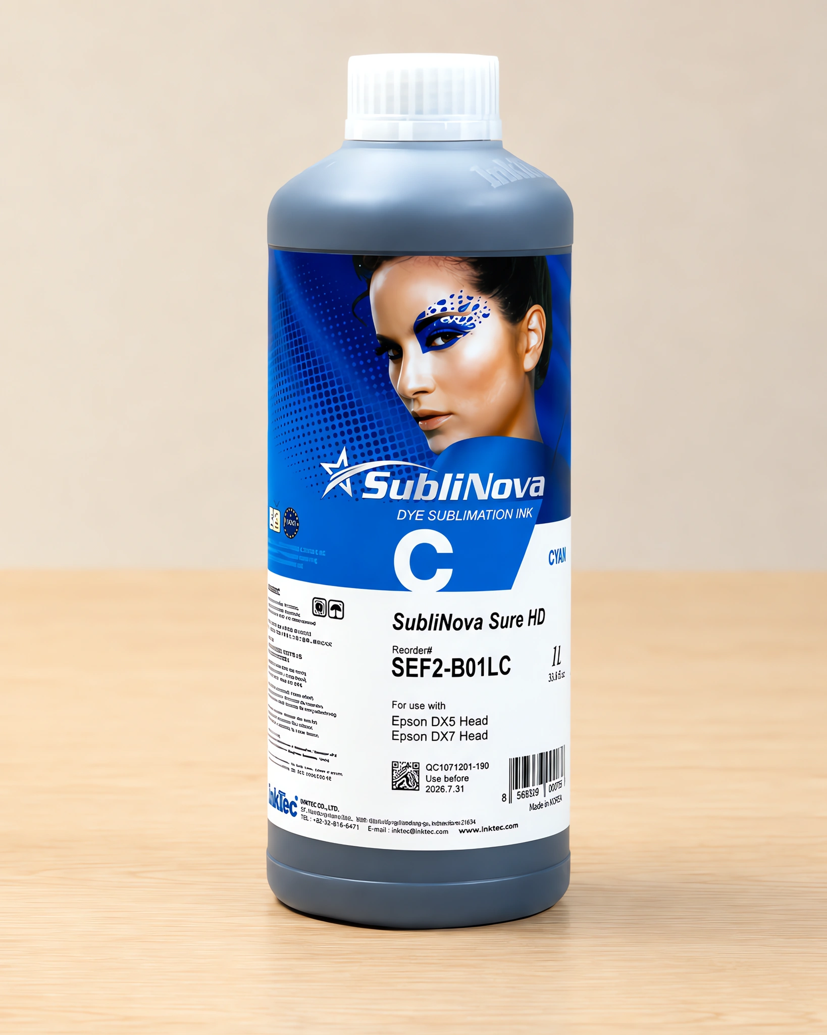Tinta para sublimar de gran formato en su envase cyan, sobre la mesa de trabajo